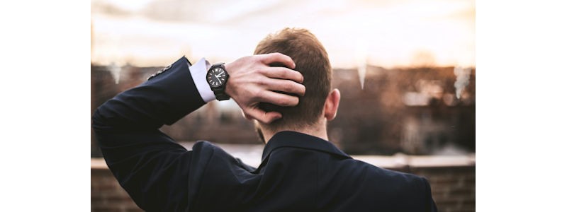 hand of a man scratching the back of his head